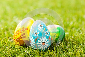 Colorful hand painted Easter eggs in grass. Spring theme