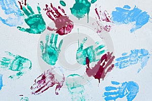 Colorful hand prints on a white wall