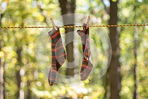 Colorful handknit socks hanging to dry on the clothesline