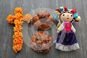 Colorful handmade cloth doll with pan de muerto from the town with sesame in the offering for the Day of the All Souls and All Sai