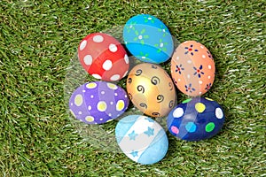 Colorful handmade easter eggs on green grass
