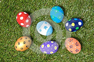 Colorful handmade easter eggs on green grass