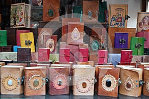 Colorful Handmade leather notebook, Books and agendas outside at a shop front for sale. Souvenir shop with handmade leather bags photo