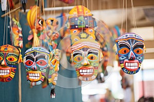 colorful handmade masks hanged on a festive stall