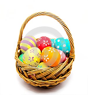 Colorful handmade painted easter eggs in the basket isolated