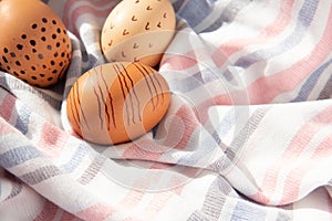 Colorful handmade painted Easter eggs on a textile background. Minimal concept