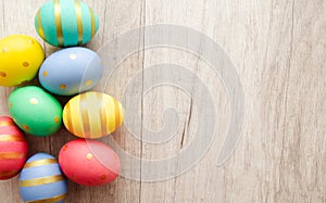Colorful handmade painted easter eggs on a wood background