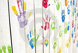 Colorful handprints on wall from an angle