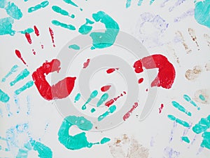 Colorful handprints on a white surface