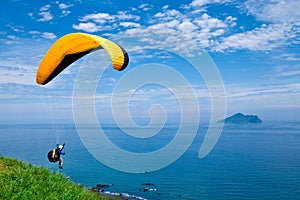 Colorful hang glider in sky