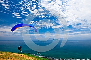 Colorful hang glider in sky