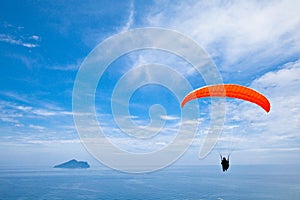 Colorful hang glider in sky