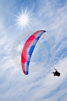 Colorful hang glider in sky