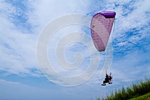 Colorful hang glider in sky