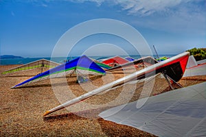 Colorful hang gliding wings lined up on top of a cliff at Fort F