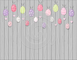 Colorful hanging easter eggs. Rustic wooden background. Cartoon style photo