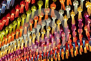 Colorful hanging lanterns lighting on night sky in loy krathong festival