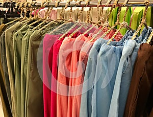 Colorful hanging woman linen pants on rack