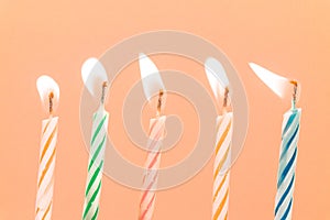 Colorful happy birthday candles close-up  with a pastel background