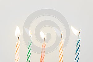 Colorful happy birthday candles close-up  with a pastel background