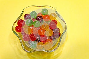 colorful hard sweet Charms candy sour balls in glass candy dish