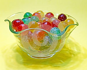 colorful hard sweet Charms candy sour balls in glass candy dish