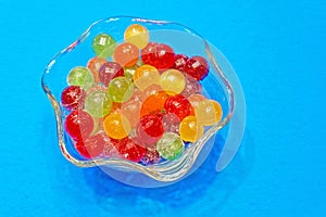 colorful hard sweet Charms candy sour balls in glass candy dish