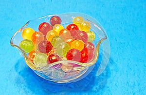 colorful hard sweet Charms candy sour balls in glass candy dish