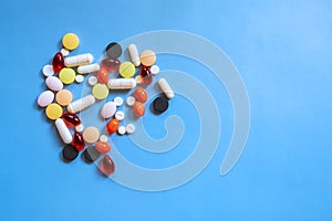 Colorful heap of pills on blue background. Heap of pills, medicine for concept design.