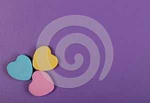 Colorful Hearts. Three Sweetheart Candy over purple background