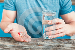 Colorful helpful drugs being in mans hand.