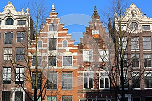 Colorful heritage buildings with gable rooftops, located along Singel Canal in Amsterdam