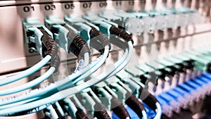 Colorful high speed optical fiber cables connected to the cloud network servers equipment switch inside modern big data center