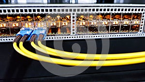 Colorful high speed optical fiber cables connected to the cloud network servers equipment switch inside modern big data center
