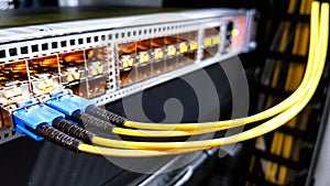 Colorful high speed optical fiber cables connected to the cloud network servers equipment switch inside modern big data center