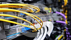 Colorful high speed optical fiber cables connected to the cloud network servers equipment switch inside modern big data center