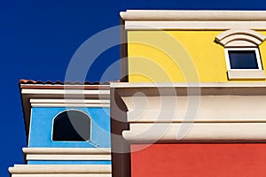 Colorful Hispanic style building facade with bright blue sky in