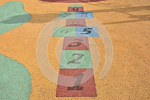 Colorful hopscotch made on the floor of a playground