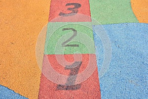 Colorful hopscotch made on the floor of a playground