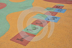 Colorful hopscotch made on the floor of a playground photo