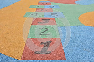 Colorful hopscotch made on the floor of a playground photo