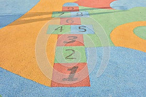 Colorful hopscotch made on the floor of a playground photo