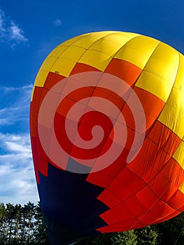 Colorful hot air balloon being deflated