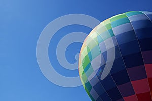 Colorful hot air balloon in flight against the blue sky