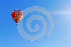 Colorful hot air balloon flying on a beautiful summer morning.