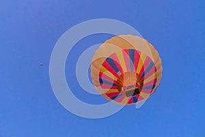 Colorful hot air balloon flying over fairy chimneys, Cappadocia, Turkey.