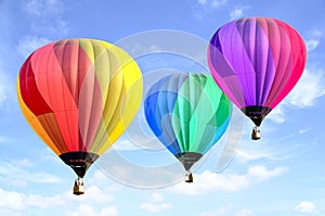 Colorful hot air balloon over bright sky with clouds