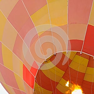 Colorful hot air balloon rises into the sky.