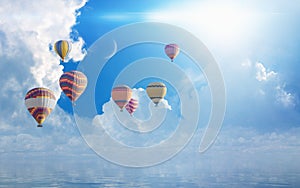 Colorful hot air balloons flying blue sea