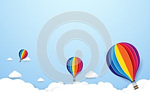 Colorful hot air balloons flying on blue sky background.
